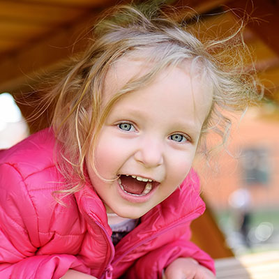 laughing toddler in playground at a Preschool & Daycare Serving Carmel, Indiana