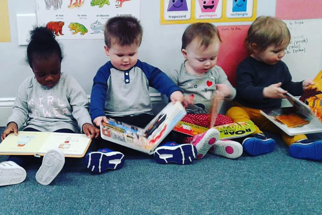 cute toddlers reading picture books at a Preschool & Daycare Serving Carmel, Indiana