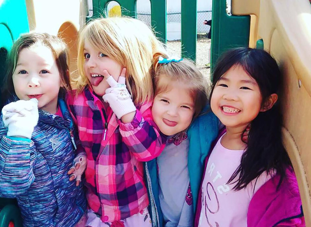 girls smiling in playground at a Preschool & Daycare Serving Carmel, Indiana