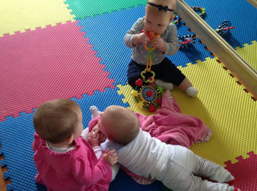 happy infants playing together on mats at a Preschool & Daycare Serving Carmel, Indiana