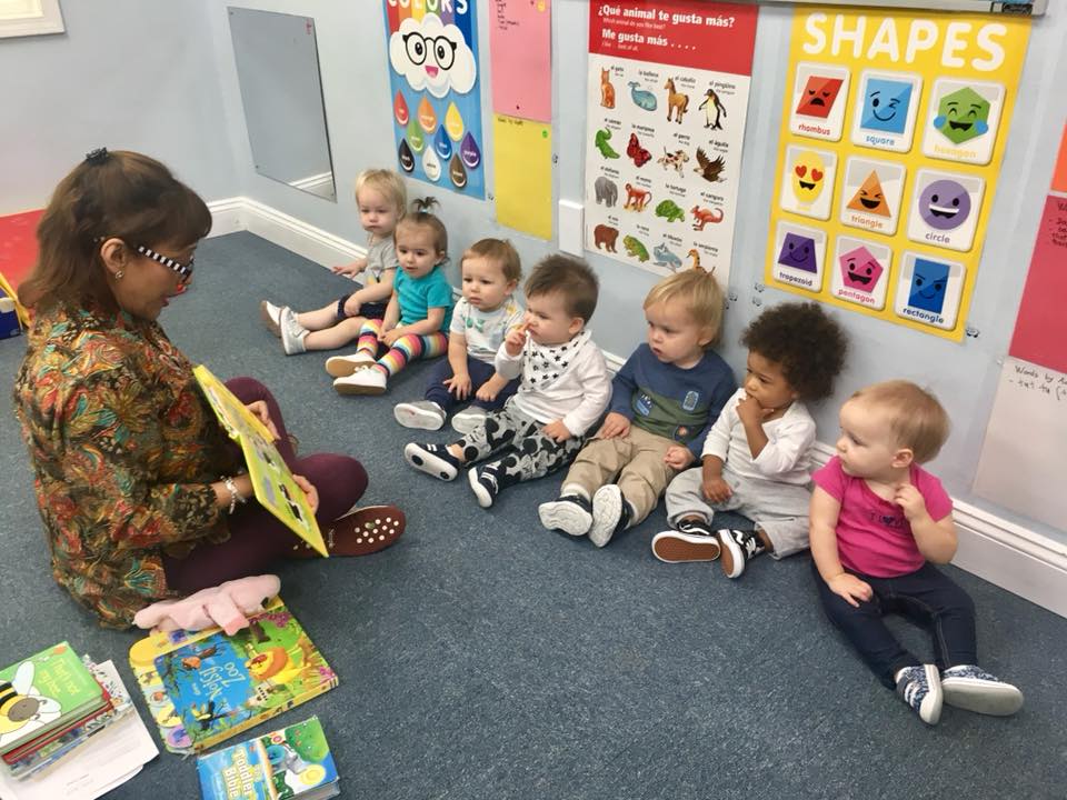 teacher reading to toddlers at a Preschool & Daycare Serving Carmel, Indiana